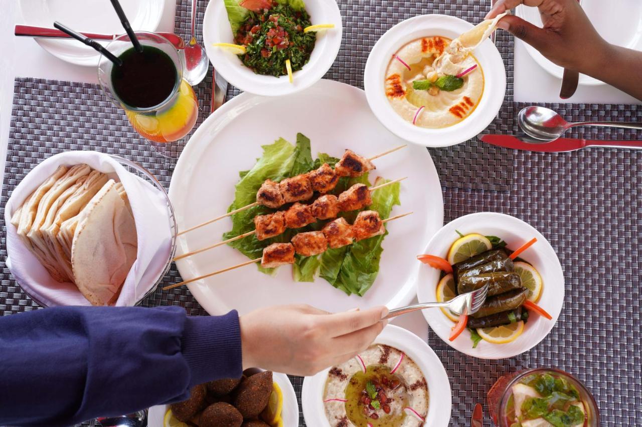 Majestic Arjaan By Rotana - Manama Aparthotel Exterior photo A selection of Middle Eastern cuisine